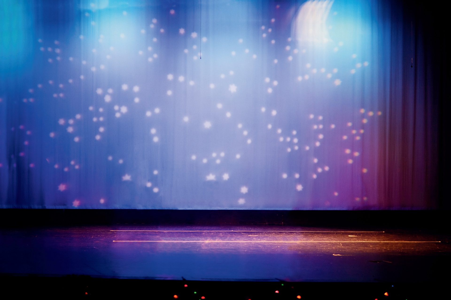 Theater stage under starry blue and purple lights