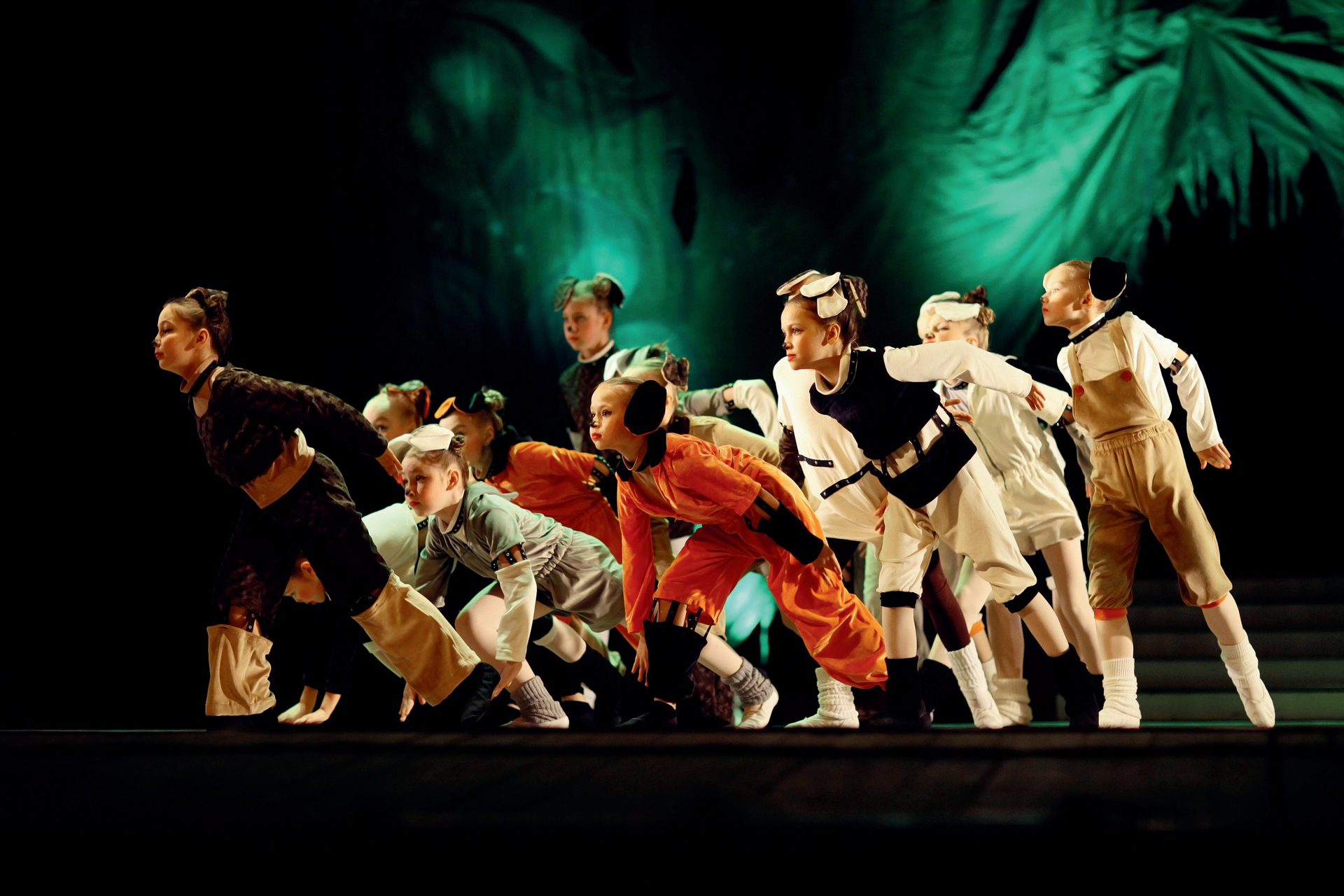 Students performing in costume on stage